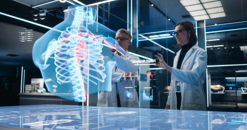 Doctors using digital tools to examine a 3D hologram of the human body.