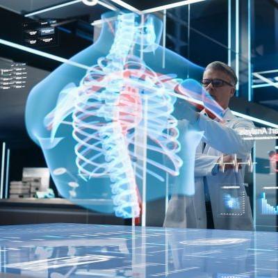 Doctors using digital tools to examine a 3D hologram of the human body.