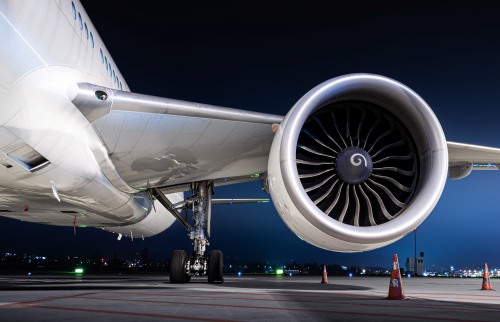Jet engine of a stationary aircraft on the runway at night.