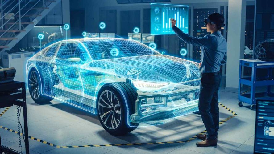 Engineer using virtual simulation to design a car in a digital environment.